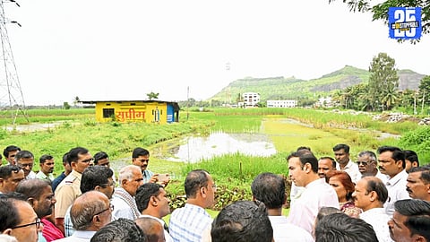 MLA Bhosale discussing with officials to resolve waterlogging issues in farmlands caused by highway construction.