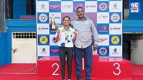 Solapur’s Shravani proudly displays her three gold medals from the Bengaluru National Swimming Championship.