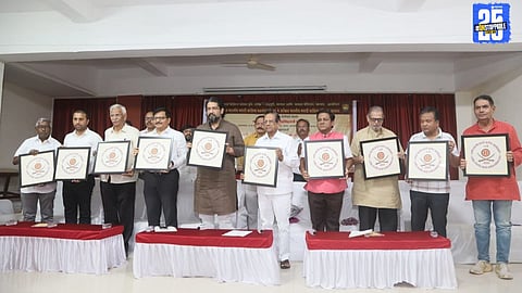 Principal Sunilkumar Lavate unveiling the emblem of the 99th All India Marathi Sahitya Sammelan with a call to connect English readers to Marathi literature.
