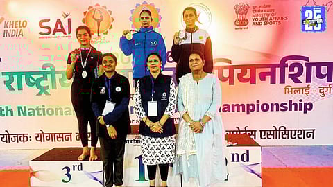Seema Pawar proudly displays her silver medal at the National Yogasana Championship.