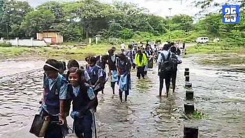 Floodwater covering the bridge on Ranand–Shikhar Shinganapur road, leaving students stranded.