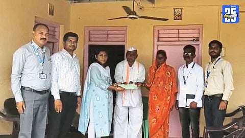 District Agriculture Superintendent interacting with farmers while handing over aid to a flood victim’s family.
