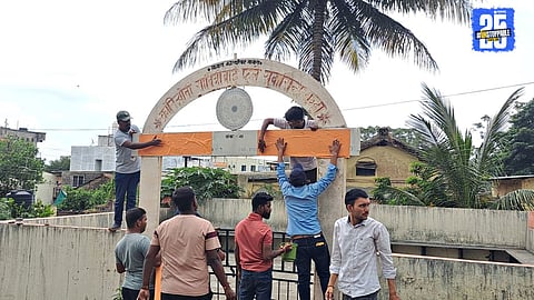 Officials removing political banners in Satara after the model code of conduct was enforced; citizens seen queuing to buy voter lists.