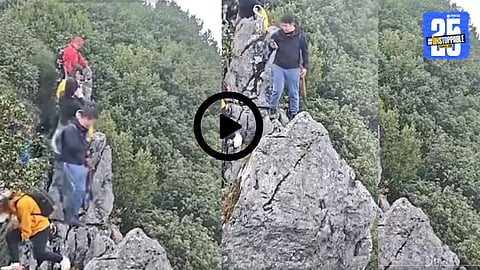 A rescue team pulls a tourist to safety after he slipped off the mountain cliff while taking a selfie.