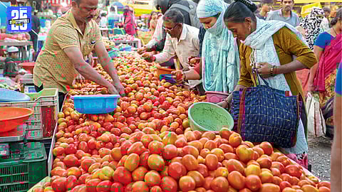 Shoppers browse fresh vegetables at a weekly market i