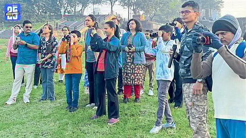 Bird watchers observing migratory birds during a field visit near Sangli.