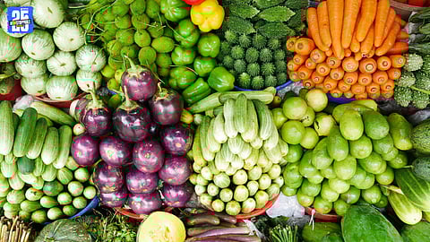Vendors selling vegetables at Ichalkaranji wholesale market amid price surge.
