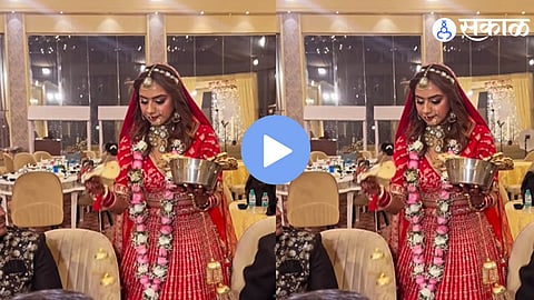 Bride and groom in wedding attire serving food to catering staff during reception, heartwarming wedding moment goes viral on social media.