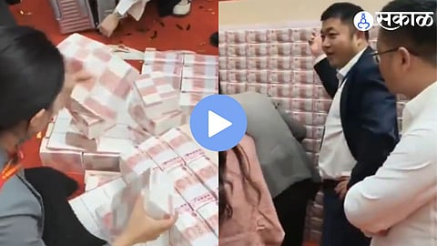 Employees of Henan Kuangshan Crane count bundles of cash during the annual bonus distribution ceremony in Henan Province, China.