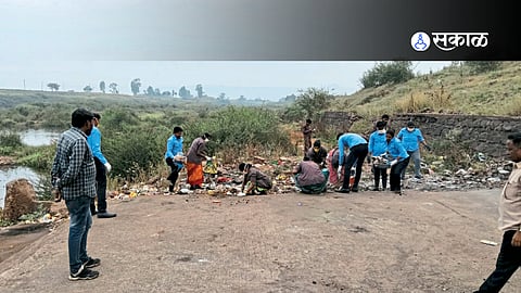 Volunteers and officials remove plastic