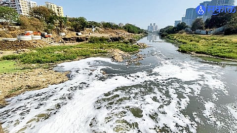 Thick foam seen floating on the polluted waters of the Mula River in Pune.