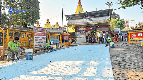 Workers paint heat-reflective