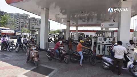 Vehicles queue at a petrol pump