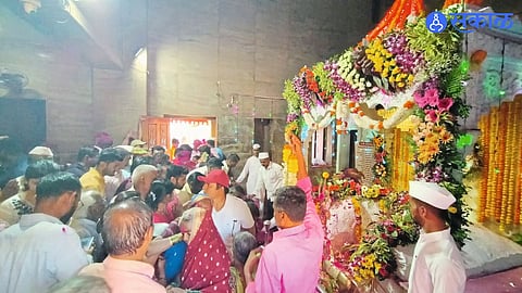 Devotees cooking traditional food on chul during Naikbaba Hill yatra amid gas shortage.