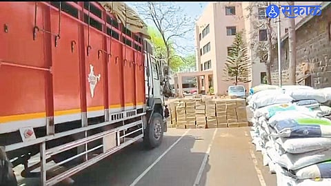 Seized liquor boxes hidden in rice bran during a police crackdown on illegal smuggling.