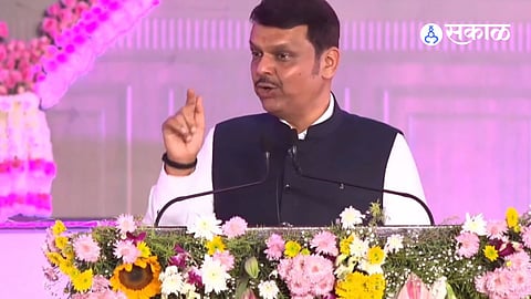 Sunetra Pawar addressing a public rally in Baramati alongside Devendra Fadnavis during the by-election campaign, emphasizing development and legacy leadership.