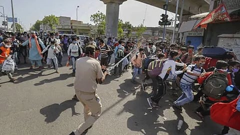 Ahmedabad Migrant workers pelts stones at police public cops lob teargas shells