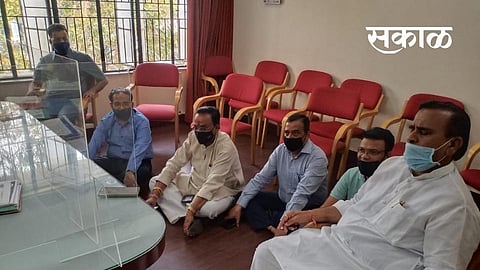Traders sit in in the administrators hall for agitation in market yard
