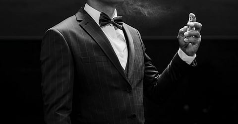 Man showing how to apply cologne properly