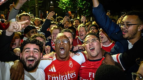 Former Arsenal player Ian Wright celebrates with fans at Emirates Stadium as Arsenal win the Premier League title 2025-2026