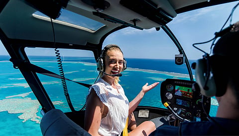 Grace Hayden takes in sweeping aerial views of the Heart Reef from a helicopter