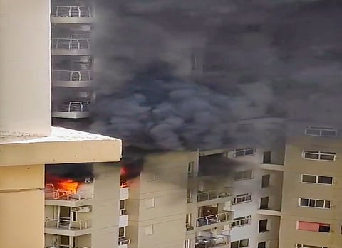 Smoke billows out after a fire broke out in the Lotus Boulevard Society at Sector 100 in Noida