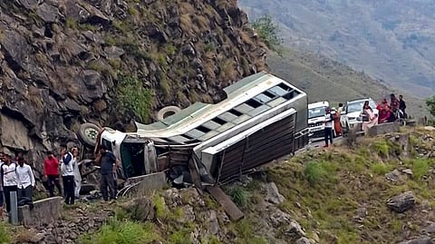 Locals gather after a Himachal Roadways Transport Corporation (HRTC) bus overturned on the Kuddu-Diltari road, in Shimla district