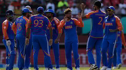 Kuldeep Yadav, center without cap, celebrates with teammates after the dismissal of Harry Brook during the ICC Men's T20 World Cup second semifinal cricket match between England and India