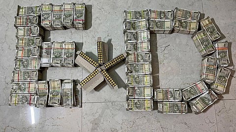 Rupees one crore in cash and bullets recovered by Enforcement Directorate (ED) sleuths from a land trader after a search in connection with an illegal land scam case, in Ranchi