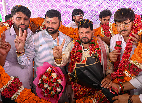 People congratulate Brij Bhushan Sharan Singh with floral garlands after he was acquitted in the sexual harassment case, in New Delhi, on Monday | PTI