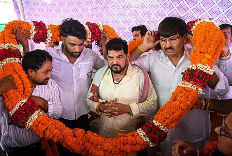 People congratulate Brij Bhushan Sharan Singh with floral garlands after he was acquitted in the sexual harassment case filed by women wrestlers, in New Delhi, on Monday | PTI