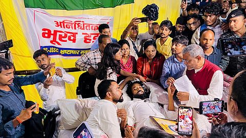 Leader of Opposition in the Jharkhand Legislative Assembly and BJP leader Babulal Marandi interacts with student leader Devendra Nath Mahato and other protesters, in Ranchi, on Wednesday | PTI