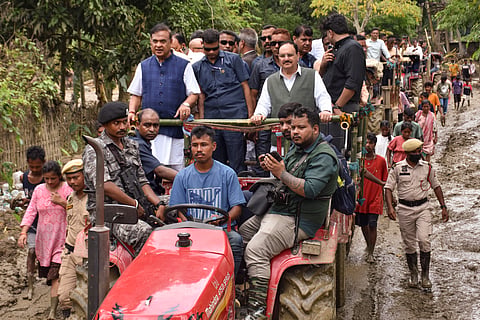 Union Health and Family Welfare minister JP Nadda along with Assam CM Himanta Biswa Sarma and others rides a tractor-trailer to visit flood-affected areas, in Sivasagar district, on Wednesday | PTI