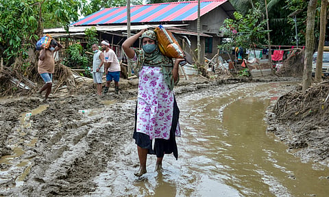 Flood-affected residents gather to receive relief materials distributed by volunteers, in Sivasagar district, Assam | File image/PTI