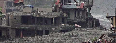 An area covered in mud and silt washed along the devastating flash floods, in Dhading district, Nepal, on Friday | PTI
