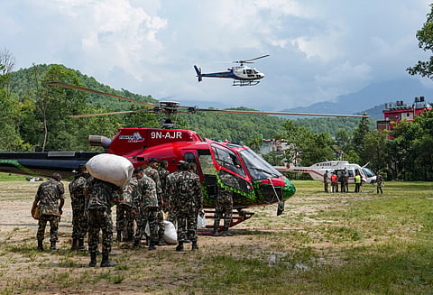 Army personnel load packages of relief material onto a rescue helicopter at an army camp, in Trishuli, Nuwakot district, Nepal, on Saturday | PTI