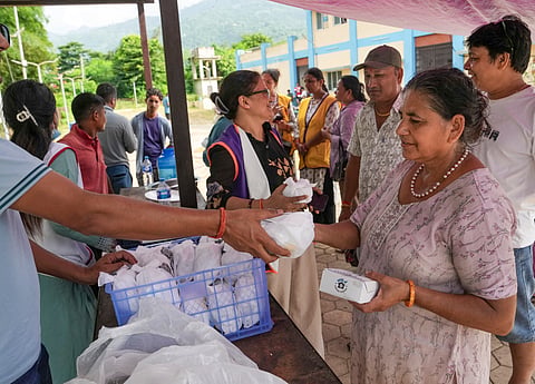 Flood victims at a relief camp set up at an ayurvedic hospital following devastating flash floods, in Kathmandu, on Saturday | PTI
