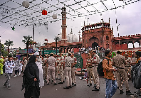 Police personnel stand guard as people arrive to offer prayers at Jama Masjid ahead of the Eid Al-Fitr festival celebrations, in New Delhi | File image/PTI