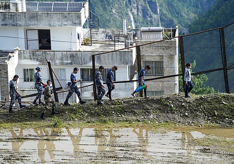 Security personnel dispatch relief material sent by India in the aftermath of the recent flash floods, at an army base camp, in Rasuwa district, Nepal, on Wednesday | PTI