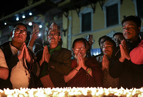 People offer prayers for the victims of the flash floods at Boudhanath Stupa, in Kathmandu | PTI
