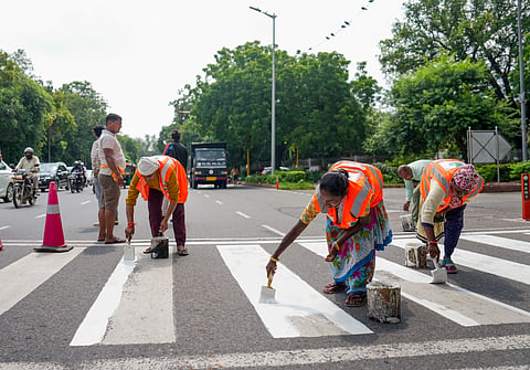 NDMC workers mark zebra crossing at India Gate circle ahead of the 18th BRICS Summit, in New Delhi | File image/PTI