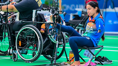 India's para-archer Sheetal Devi, right, competes during the World Archery Para Series, in Ahmedabad