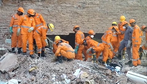 NDRF personnel conduct a rescue operation in a congested bylane in Satya Niketan near Delhi University's south campus, on Monday | PTI