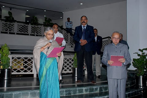 Rakesh Mehta is seen during his oath-taking ceremony with then Delhi CM Sheila Dikshit, in this file image dated November 19, 2010 