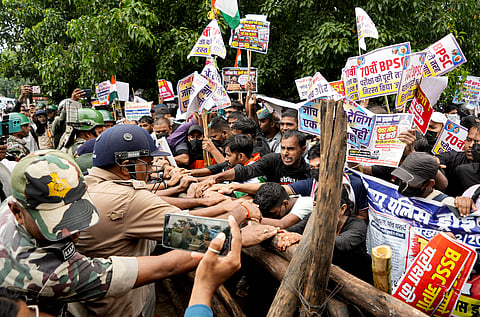 Police personnel stop candidates demanding cancellation and re-conduct of Bihar Police Sub-Inspector recruitment exam and the 70th BPSC Combined Competitive Examination, in Patna, on Tuesday | PTI