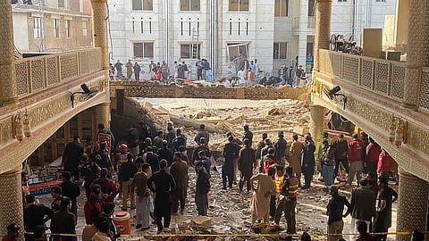 At least 15 policemen among dead as seven-member militant squad launches coordinated assault during Friday prayers in restive Khyber Pakhtunkhwa

