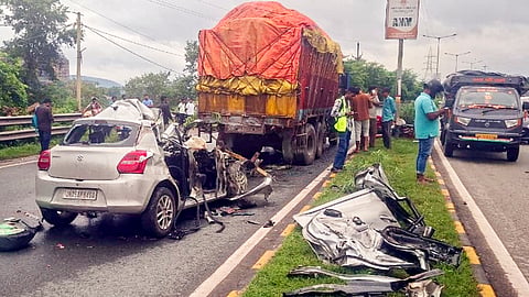People gather at the site after a car rammed into a stationary truck, in Jamshedpur, on Thursday | PTI