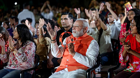 Modi had joined the rhythm with a tambourine and clapped along as musicians performed bhajans before the gathering