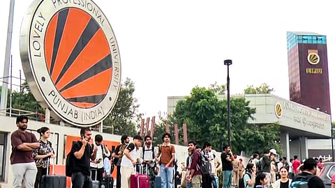Students carry luggage and leave LPU campus following protests over claims that a female student was raped by an outsider in the university premises, in Phagwara, on Monday | PTI