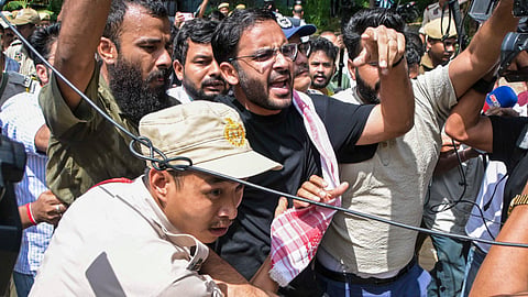 Police personnel detain CJP co-convenor Ashutosh Ranka and other party activists as they raise slogansg near the Assam Secretariat, in Guwahati, on Sunday | PTI